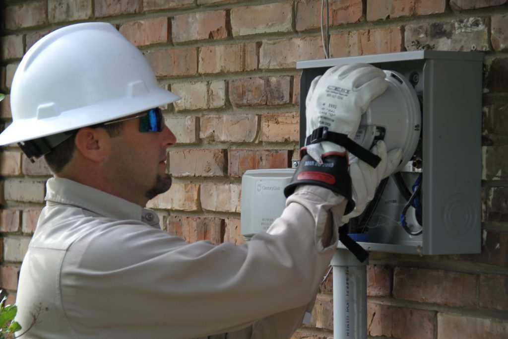 Technician installs electrical meter